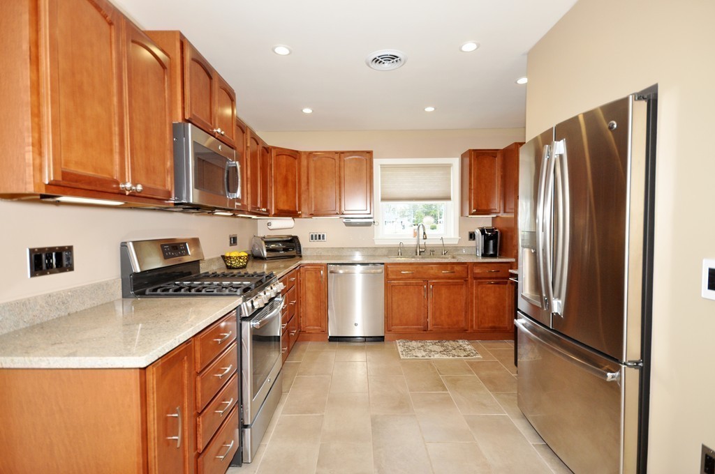 5 Arlington Road Natick, MA 01760 - Photo 3 of 15 a kitchen with stainless steel appliances granite countertop a refrigerator a stove a sink and a microwave