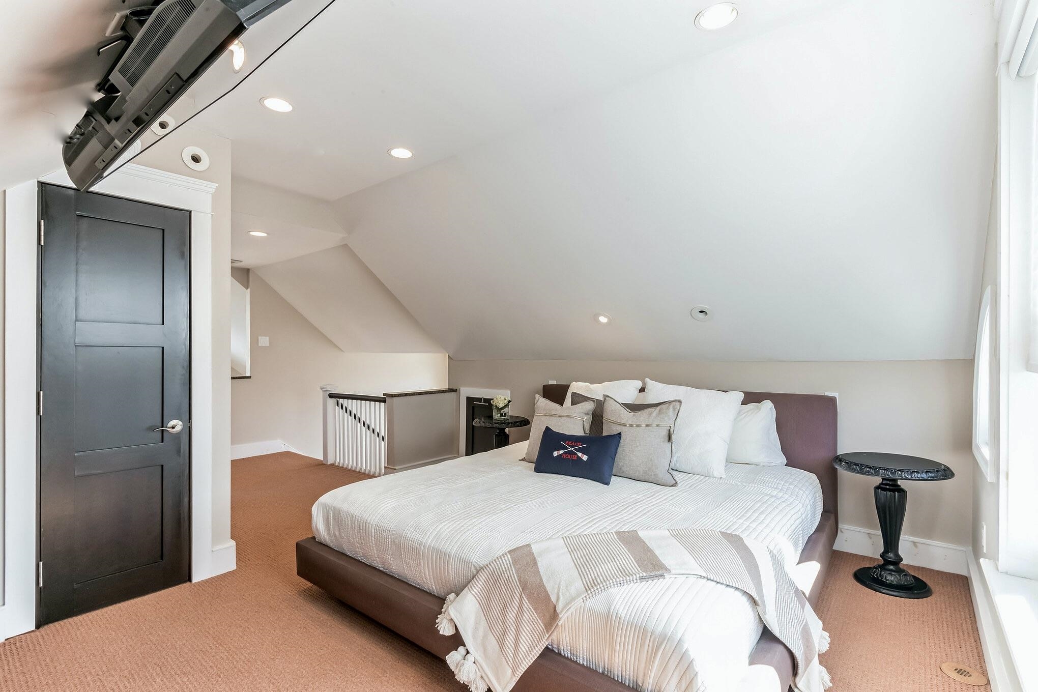 96 Commonwealth Avenue Strathmere, NJ 08248 - Photo 17 of 37 a bedroom with a bed and a chandelier