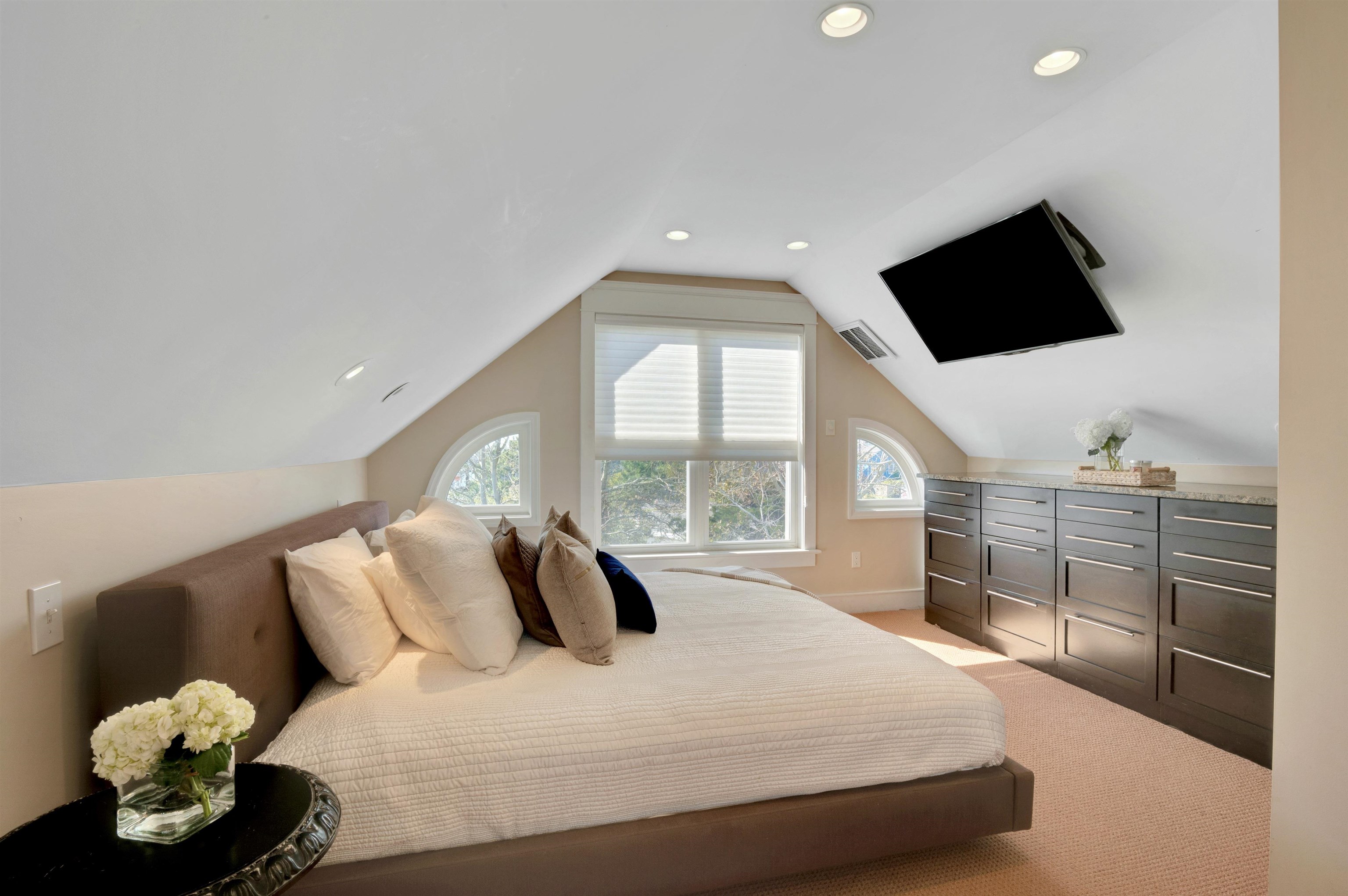 96 Commonwealth Avenue Strathmere, NJ 08248 - Photo 18 of 37 a bedroom with a large bed and a flat tv screen