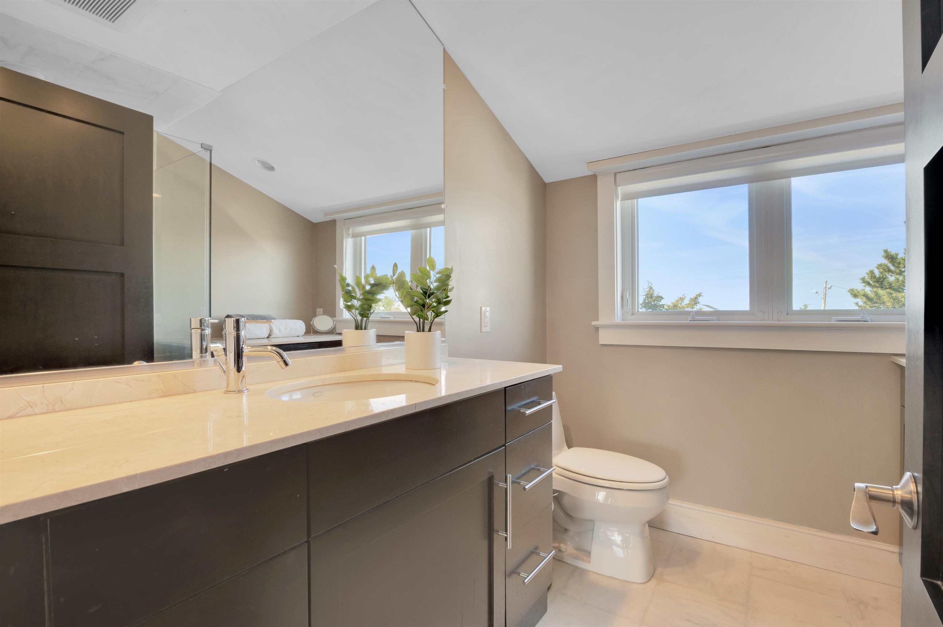 96 Commonwealth Avenue Strathmere, NJ 08248 - Photo 19 of 37 a bathroom with a granite countertop sink a toilet and a mirror