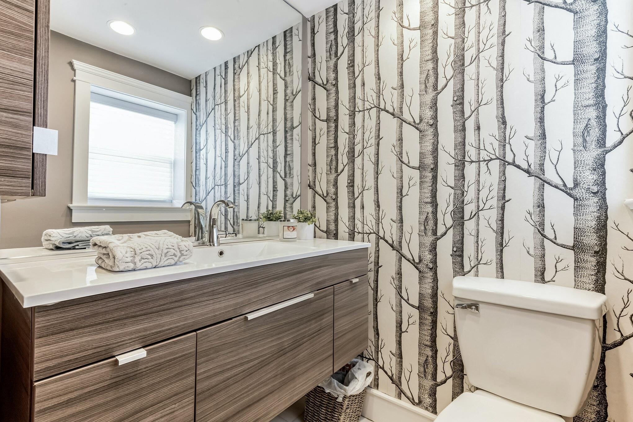 96 Commonwealth Avenue Strathmere, NJ 08248 - Photo 28 of 37 a bathroom with a granite countertop sink and a mirror