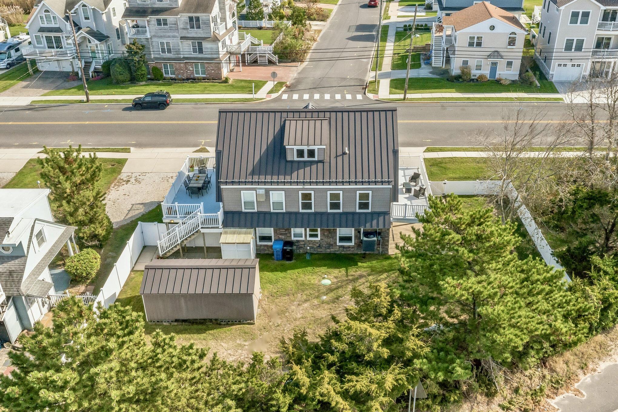 96 Commonwealth Avenue Strathmere, NJ 08248 - Photo 30 of 37 front view of a house with a swimming pool
