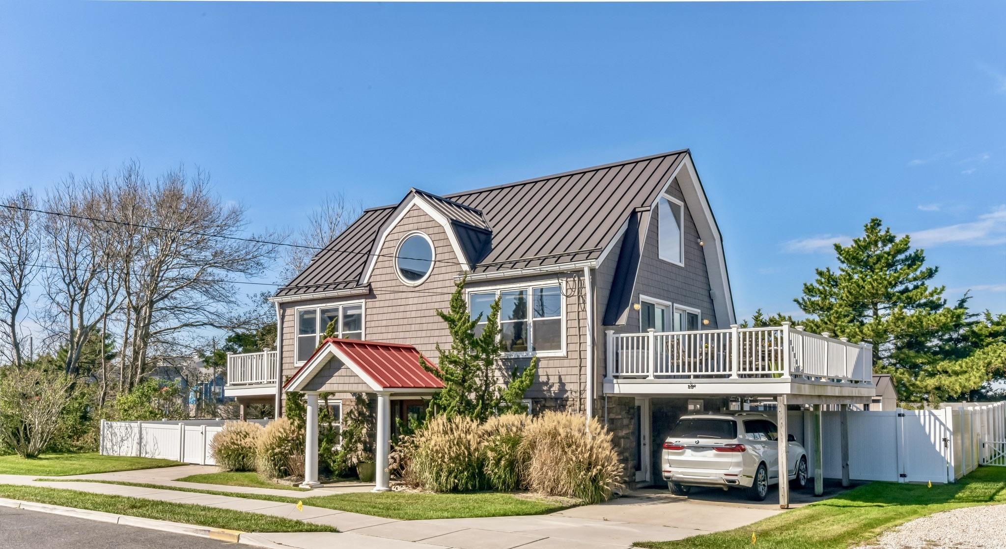 96 Commonwealth Avenue Strathmere, NJ 08248 - Photo 37 of 37 a front view of house with yard and trees in the background