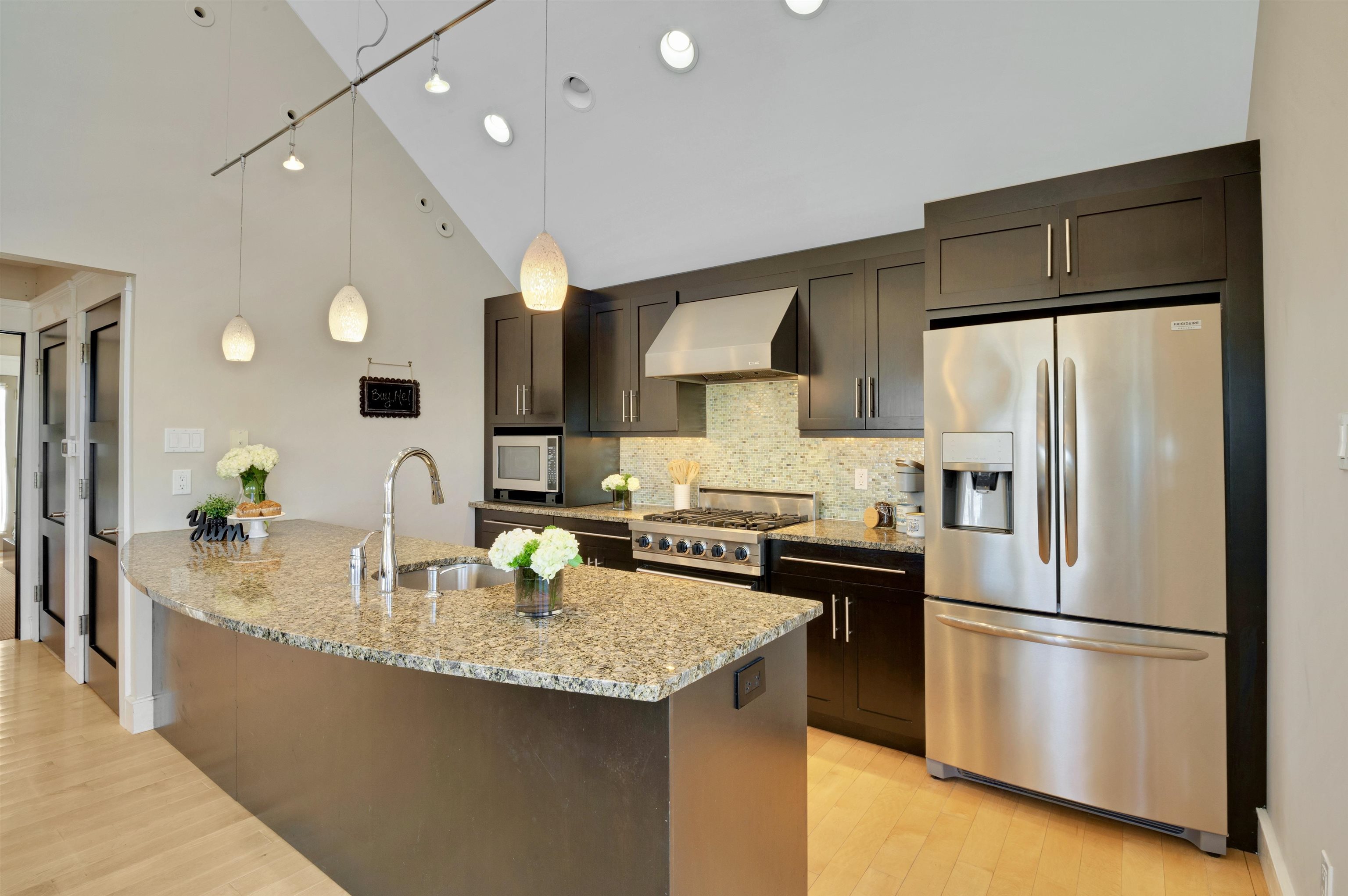 96 Commonwealth Avenue Strathmere, NJ 08248 - Photo 4 of 37 a kitchen with stainless steel appliances granite countertop a refrigerator a sink a stove and a refrigerator