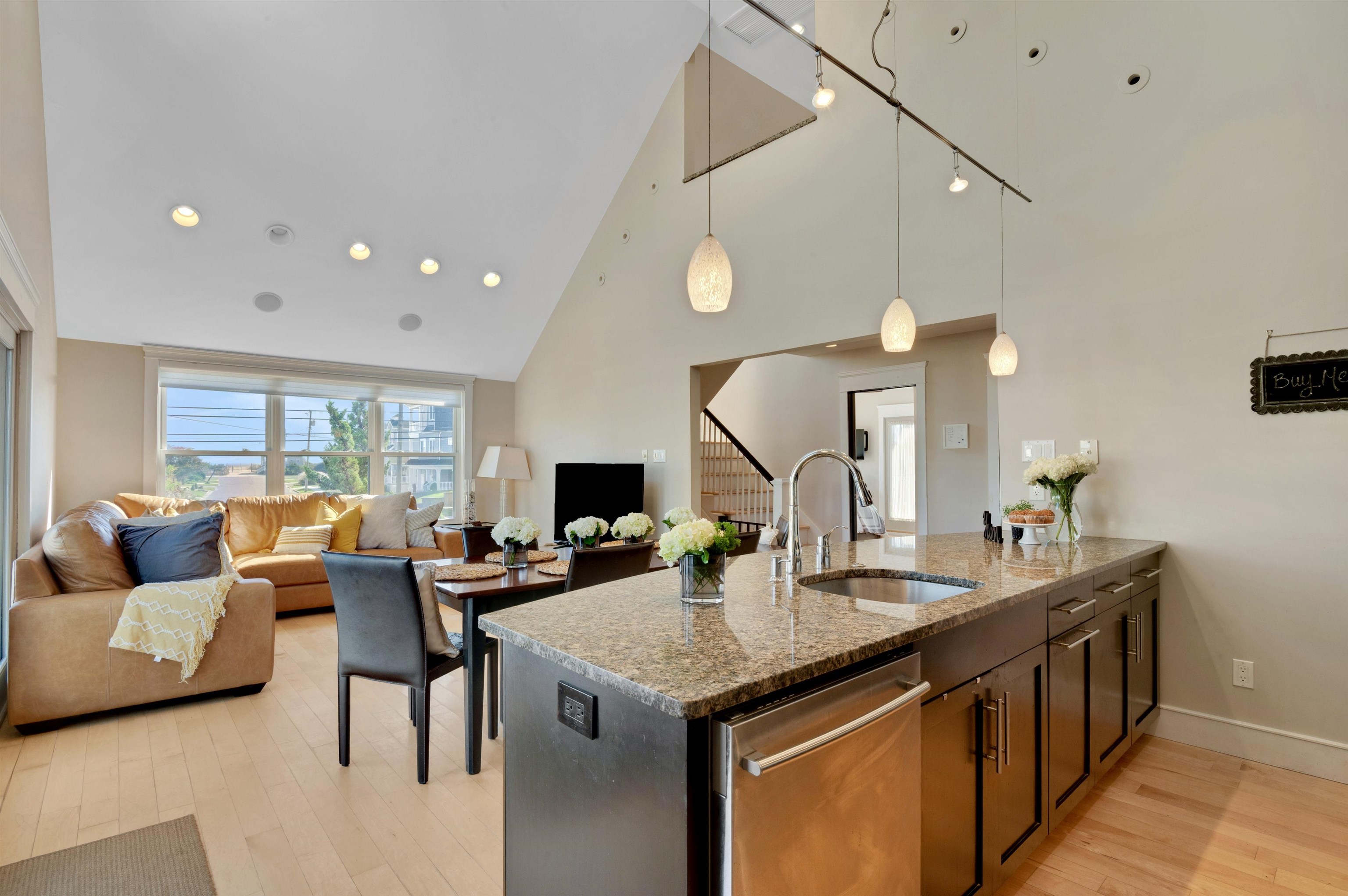 96 Commonwealth Avenue Strathmere, NJ 08248 - Photo 6 of 37 a living room with stainless steel appliances kitchen island granite countertop a table chairs and a couch