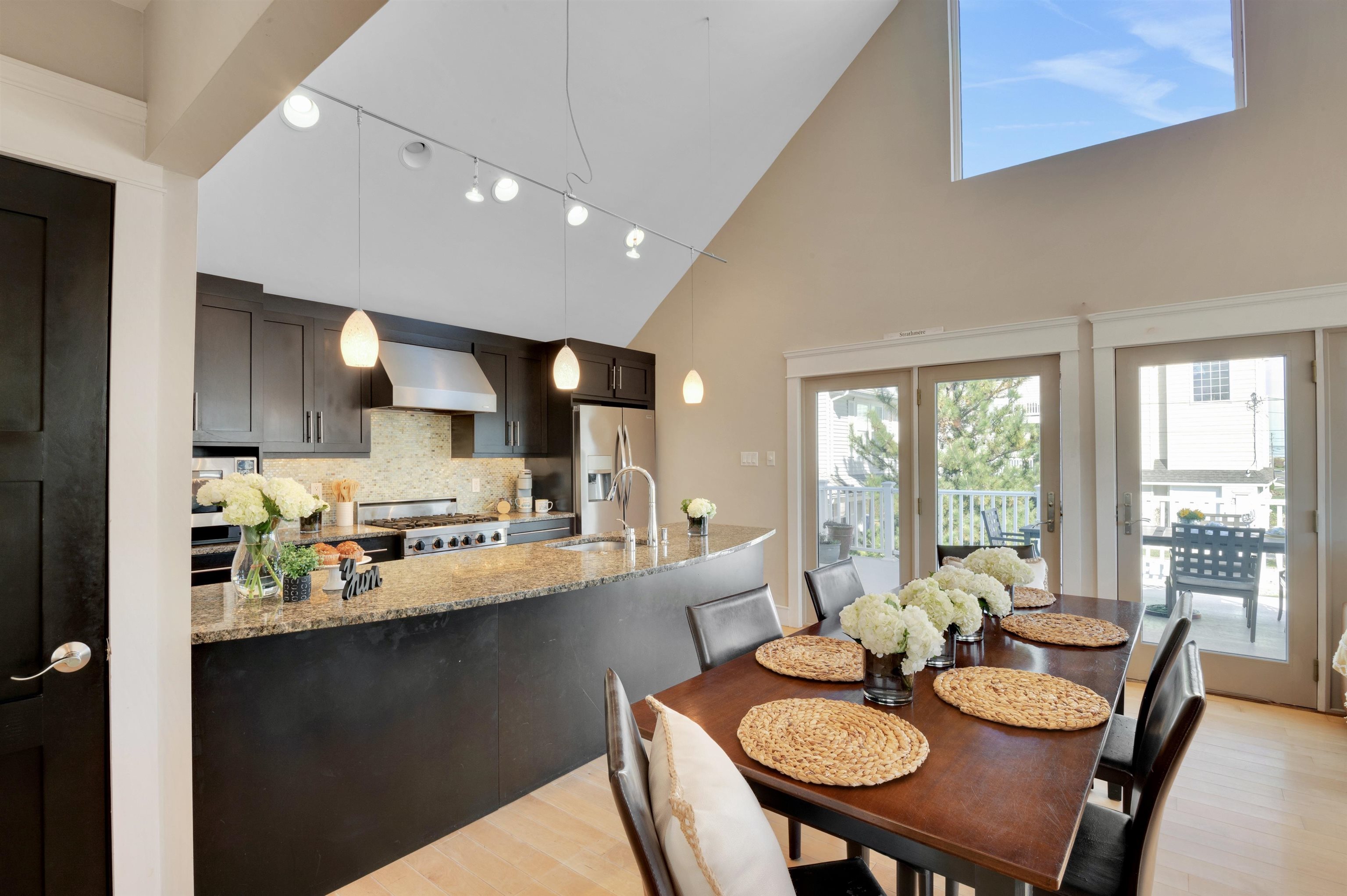 96 Commonwealth Avenue Strathmere, NJ 08248 - Photo 10 of 37 a large kitchen with a table and chairs
