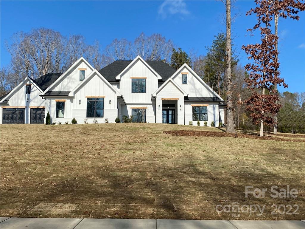 a big house with a big yard and large trees