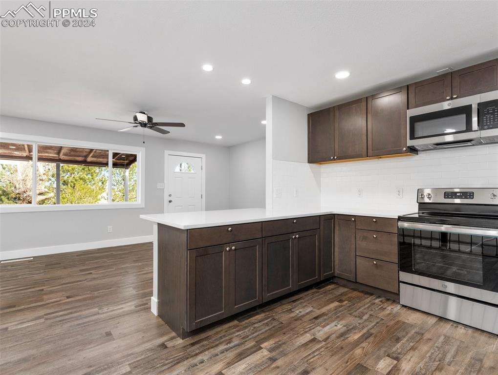 6455 Galbreth Road Pueblo, CO 81005 - Photo 14 of 37 a kitchen with stainless steel appliances granite countertop a stove and a sink