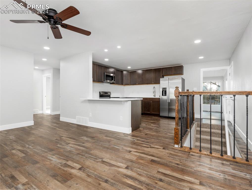 6455 Galbreth Road Pueblo, CO 81005 - Photo 15 of 37 a view of kitchen with stainless steel appliances wooden floor and large window