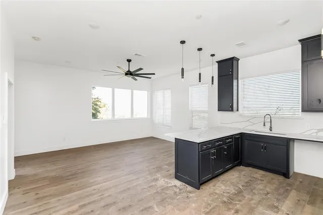 a view of a room with a sink and cabinets