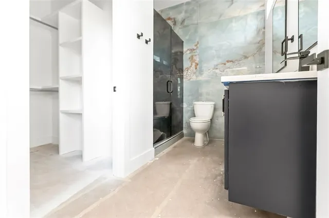 a bathroom with a toilet sink and mirror