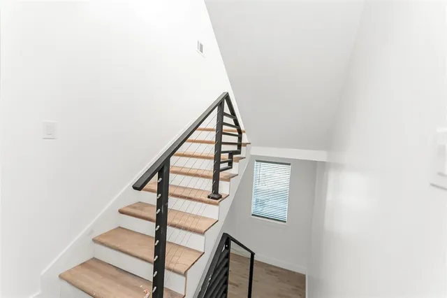 a view of a kitchen with fridge and workspace