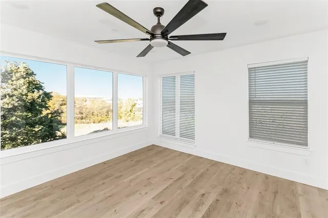 wooden floor in an empty room with a window