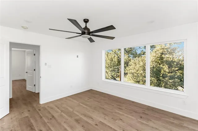 a view of a livingroom with a ceiling fan and window