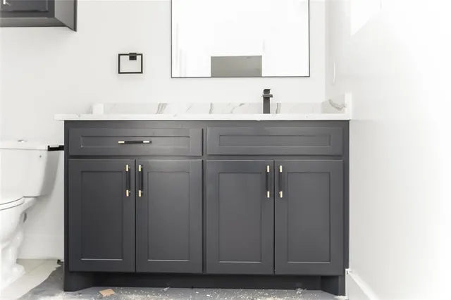 a view of a big room with wooden floor and windows