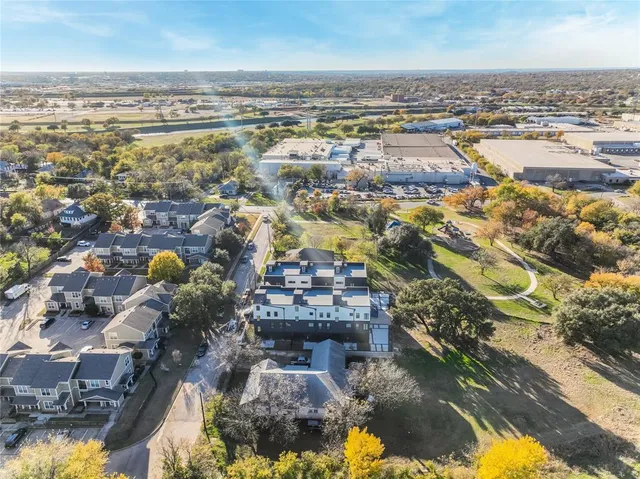 an aerial view of residential building and lake