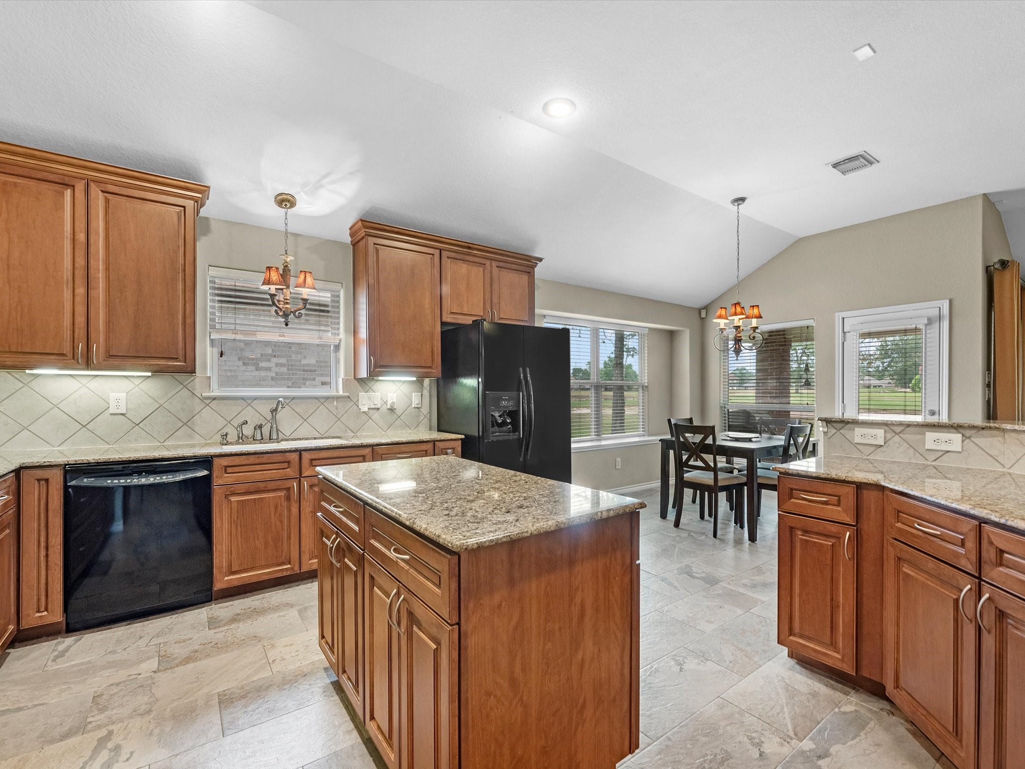 19019 Relay Road Humble, TX 77346 - Photo 15 of 31 a kitchen with stainless steel appliances granite countertop table chairs and a sink