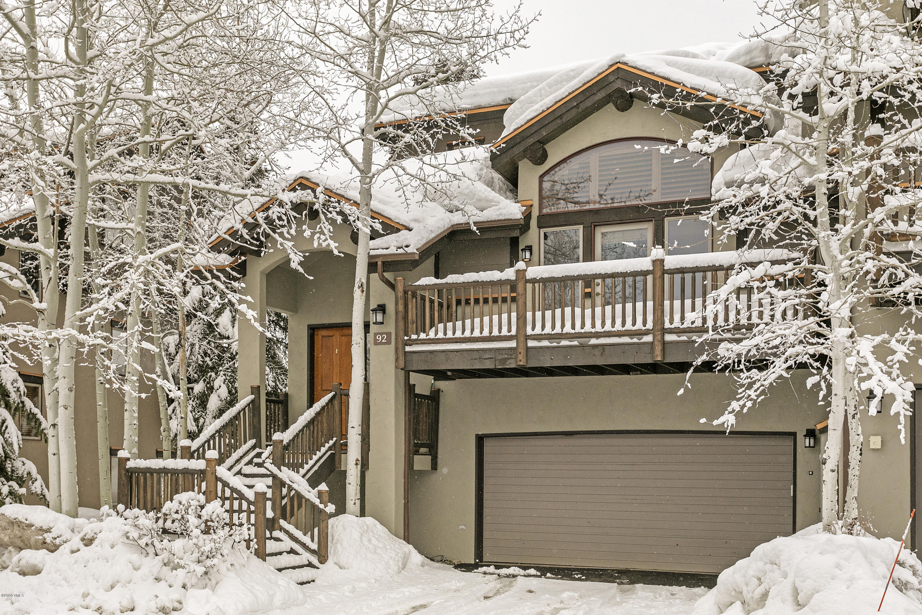 a view of a house with a large tree