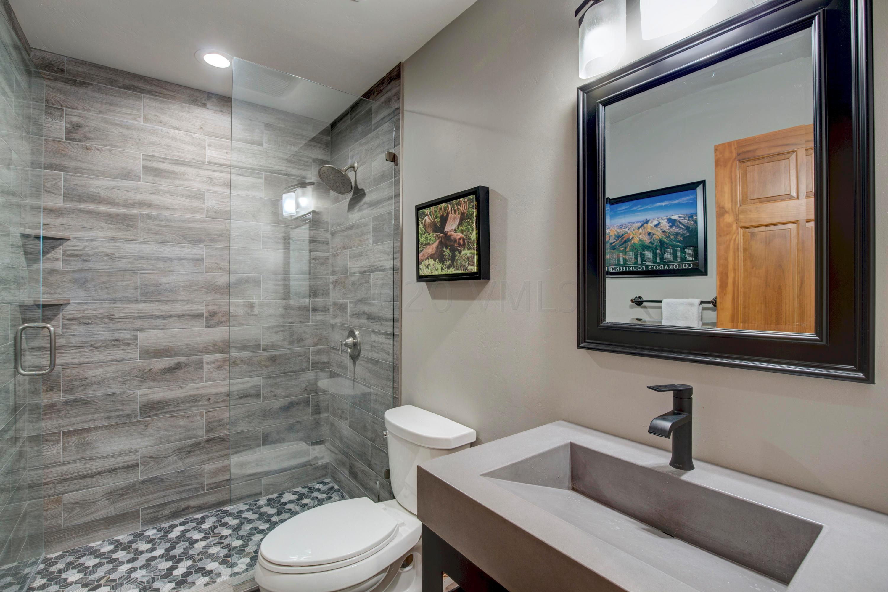 92 Knudson Ranch Road Edwards, CO 81632 - Photo 14 of 26 a bathroom with a toilet a sink a mirror and a shower