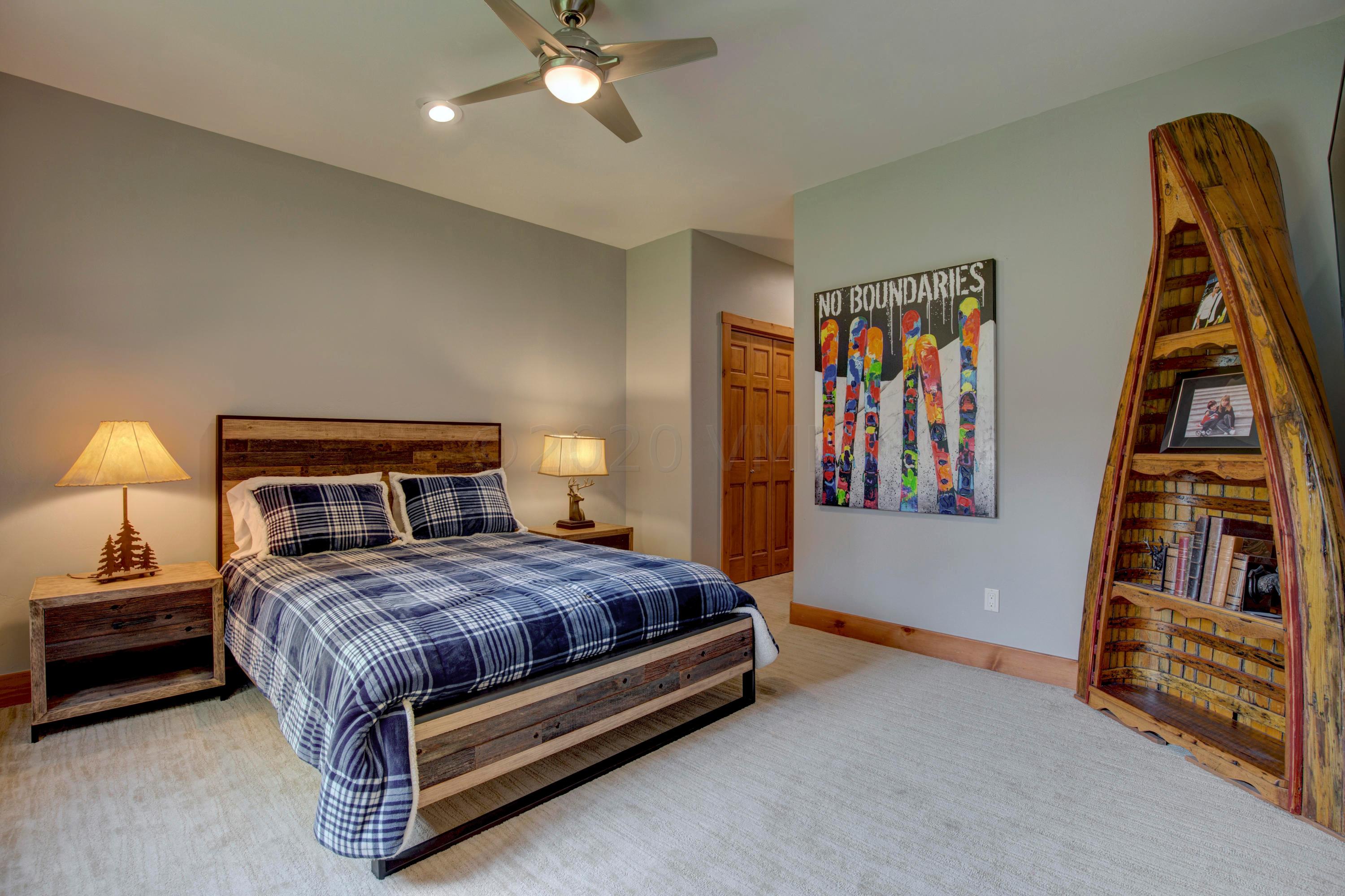 92 Knudson Ranch Road Edwards, CO 81632 - Photo 20 of 26 a bedroom with a bed and a night stand