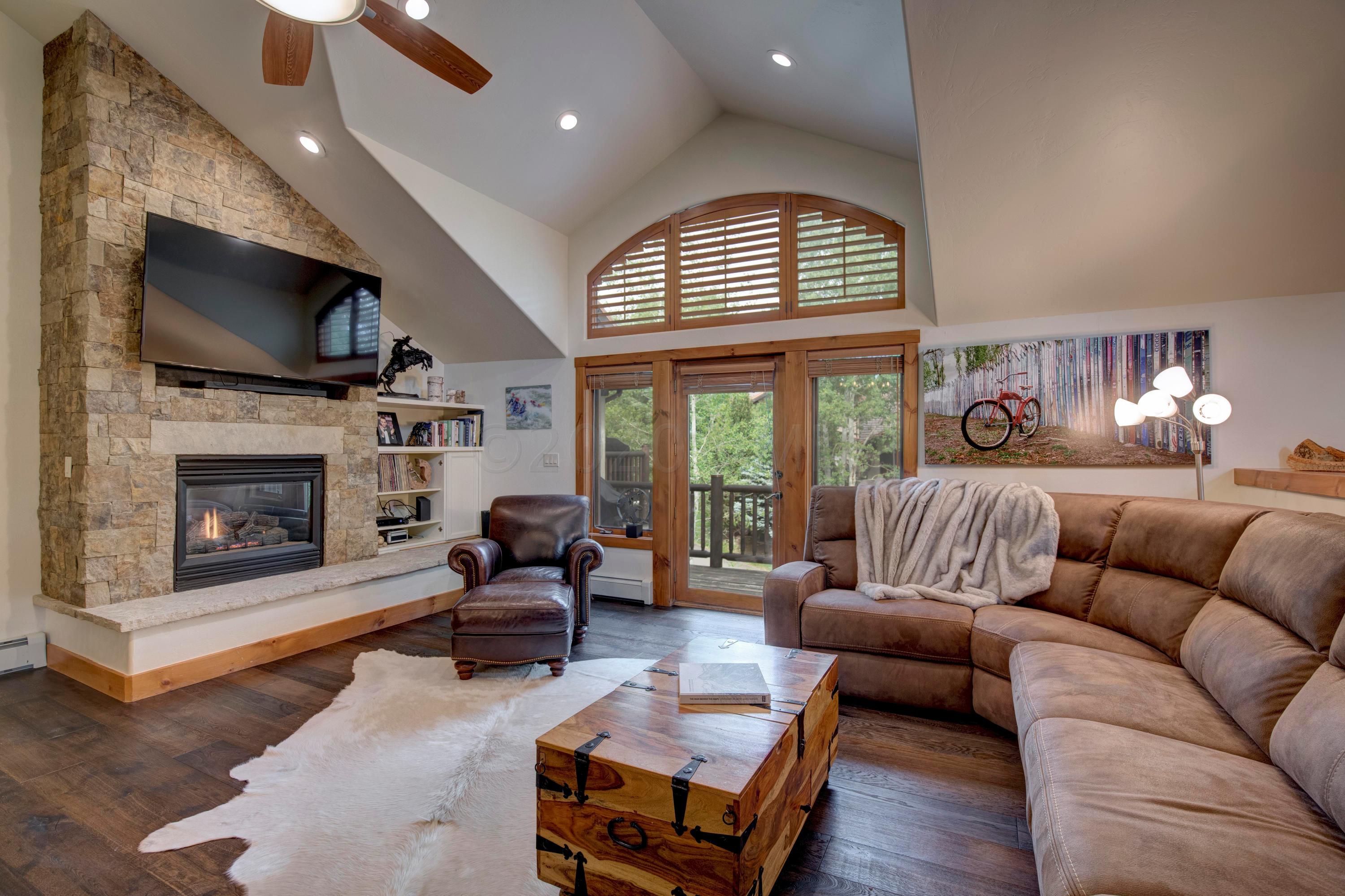 92 Knudson Ranch Road Edwards, CO 81632 - Photo 2 of 26 a living room with furniture fireplace and flat screen tv