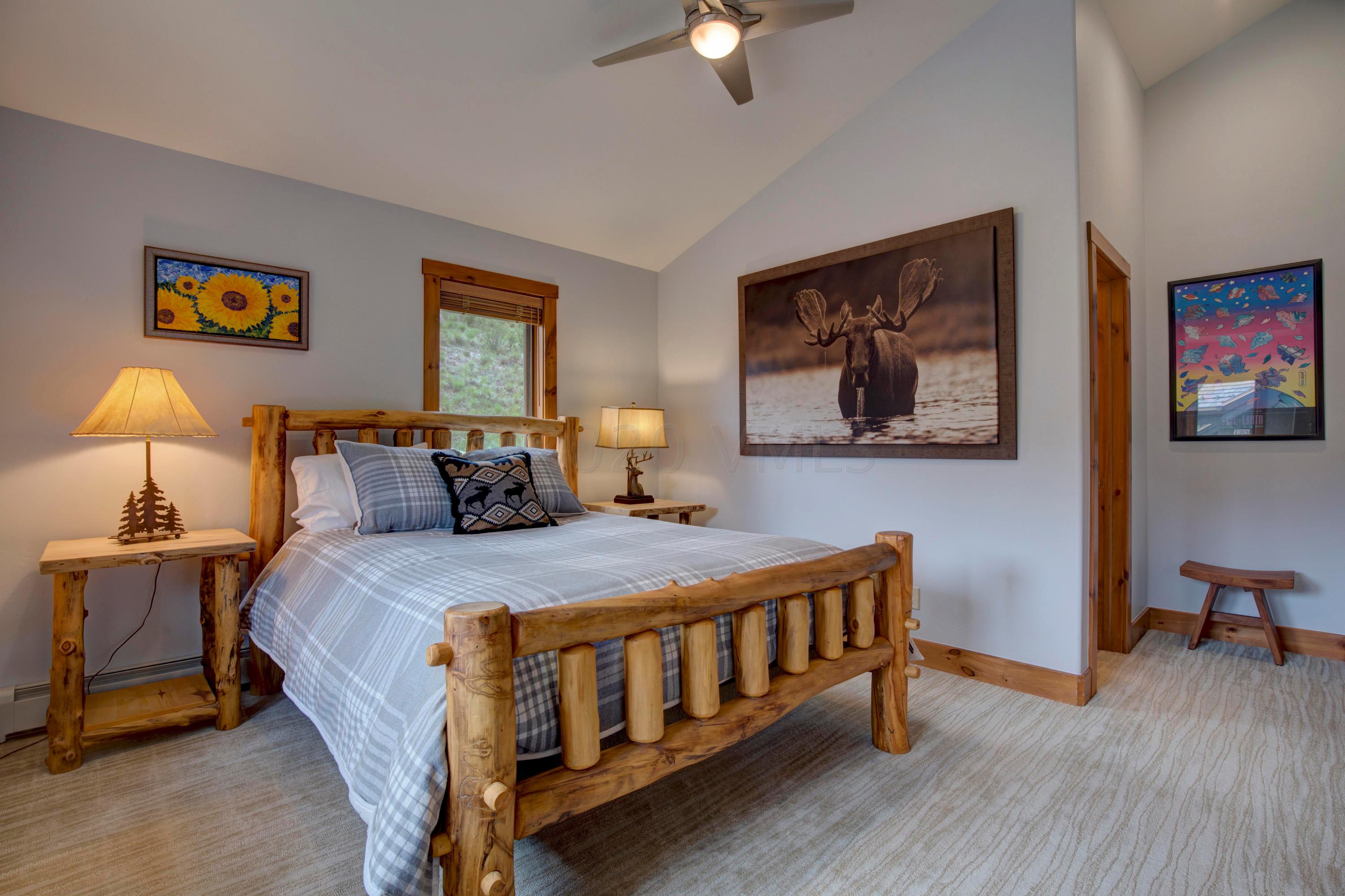 92 Knudson Ranch Road Edwards, CO 81632 - Photo 24 of 26 a bed room with a bed and a chandelier