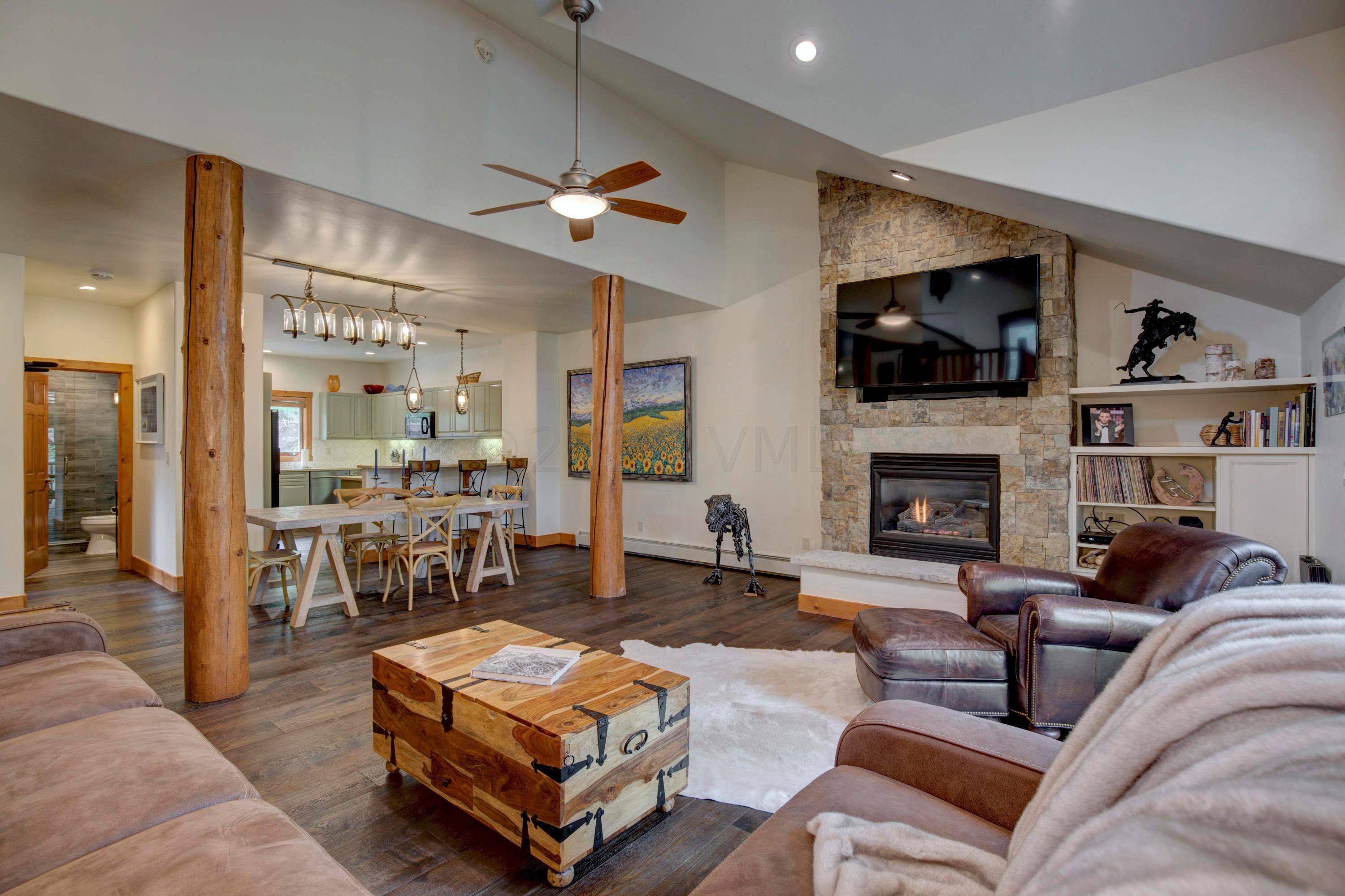 92 Knudson Ranch Road Edwards, CO 81632 - Photo 5 of 26 a living room with furniture a flat screen tv and a fireplace