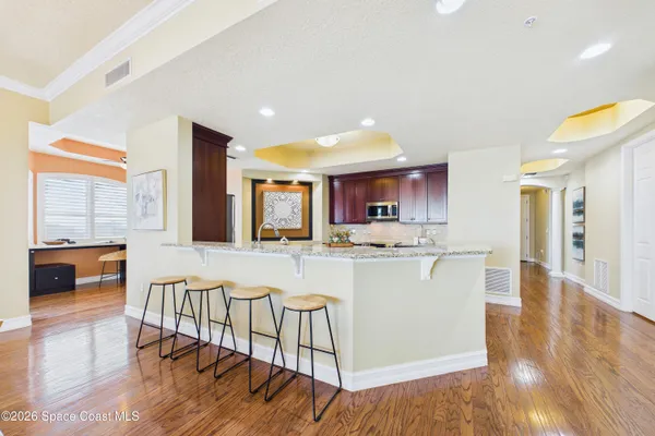 a spacious bathroom with a granite countertop sink a mirror and a shower