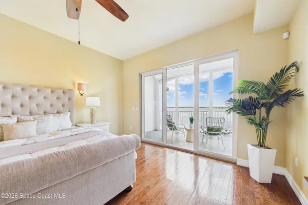 a bedroom with a bed a chandelier and a window
