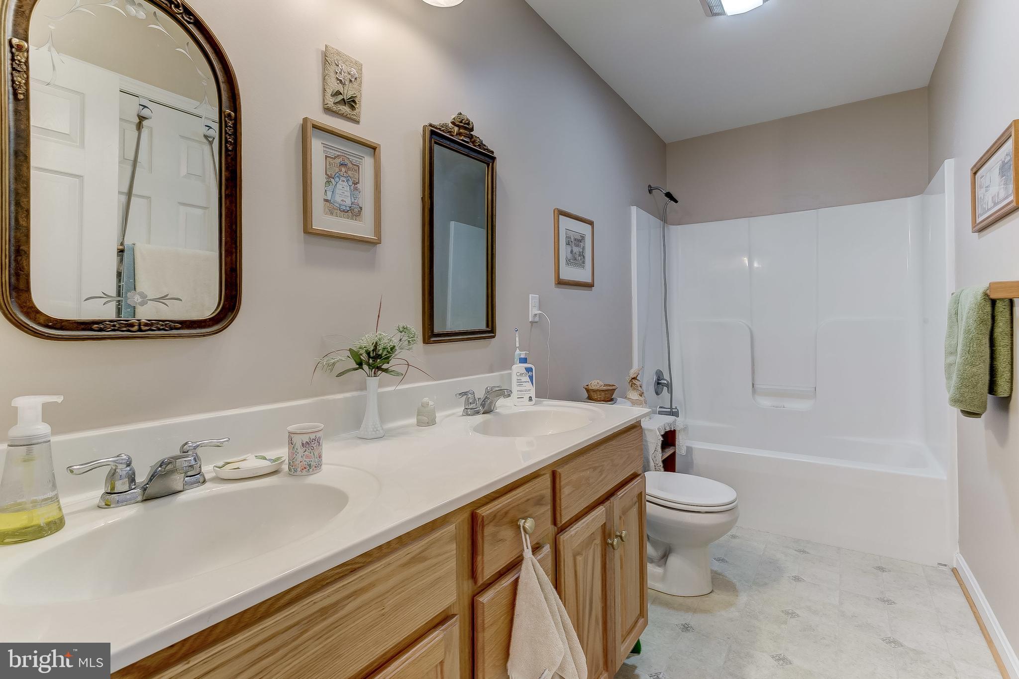 630 Muller Road Westminster, MD 21157 - Photo 22 of 39 a bathroom with a granite countertop sink mirror vanity bathtub and a toilet