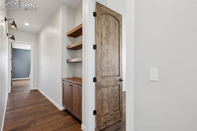 24365 Murphy Road Calhan, CO 80808 - Photo 27 of 48 Corridor featuring dark wood-style flooring and recessed lighting