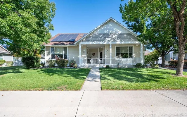 a front view of house with yard and green space
