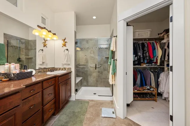 a bathroom with a double vanity sink and a shower