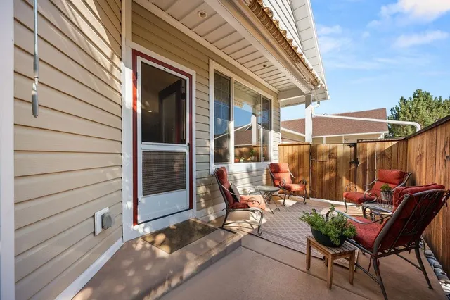 a backyard of a house with table and chairs