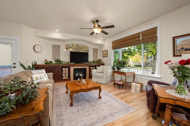 a living room with furniture a flat screen tv and a large window
