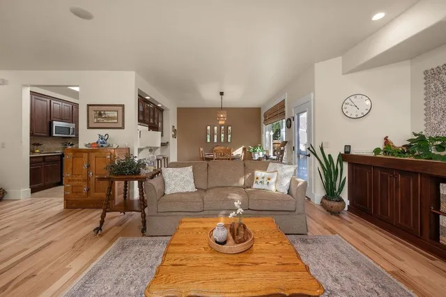 a living room with furniture and wooden floor