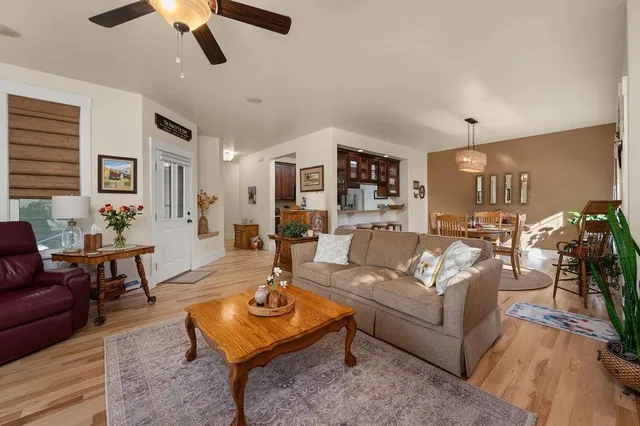 a living room with furniture and kitchen view
