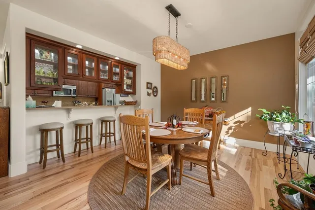 a view of a dining room with furniture window and wooden floor