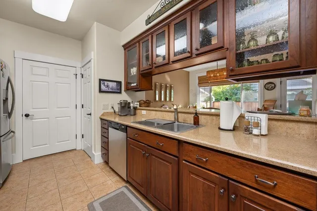 a kitchen with stainless steel appliances granite countertop a sink and cabinets