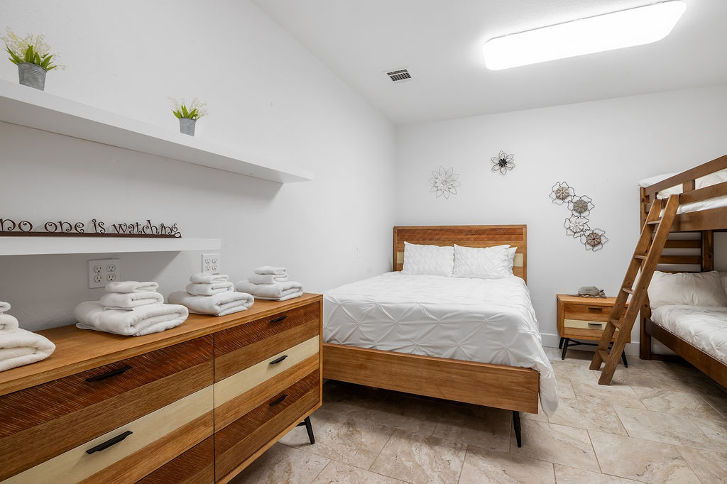 13326 Trautwein Road Austin, TX 78737 - Photo 25 of 38 Bedroom featuring stone tile flooring and vaulted ceiling