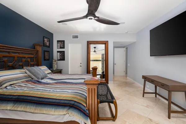 a bedroom with a bed and a flat screen tv