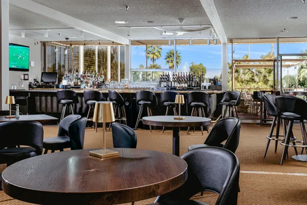 a dining area with a table and chairs