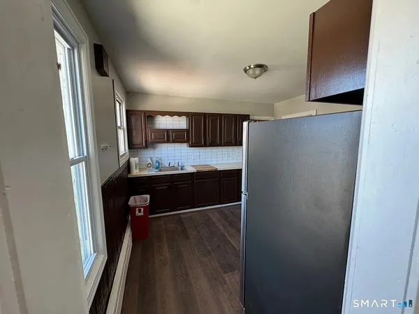 a kitchen with a refrigerator and a stove top oven