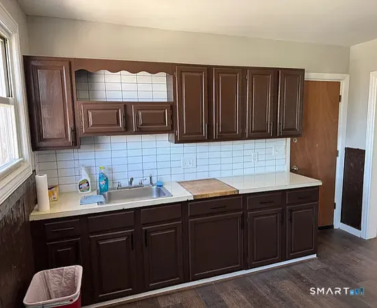 a kitchen with stainless steel appliances granite countertop wooden cabinets a sink and dishwasher