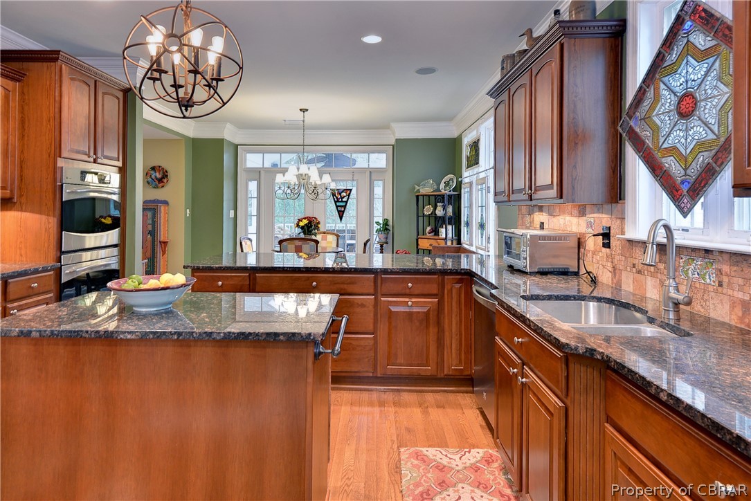 4235 Old Lock Road Williamsburg, VA 23188 - Photo 10 of 46 Fabulous kitchen includes tons of workspace and cabinetry, pantry, tiled backsplash, double ovens, and gas cooktop.