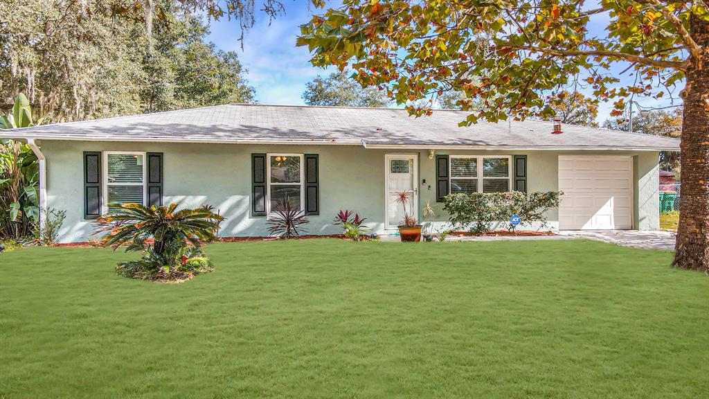 a front view of house with a garden and patio