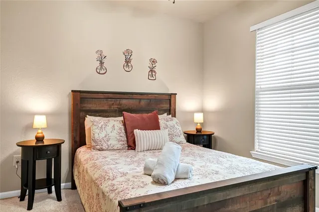 a bedroom with a bed and a painting on the wall