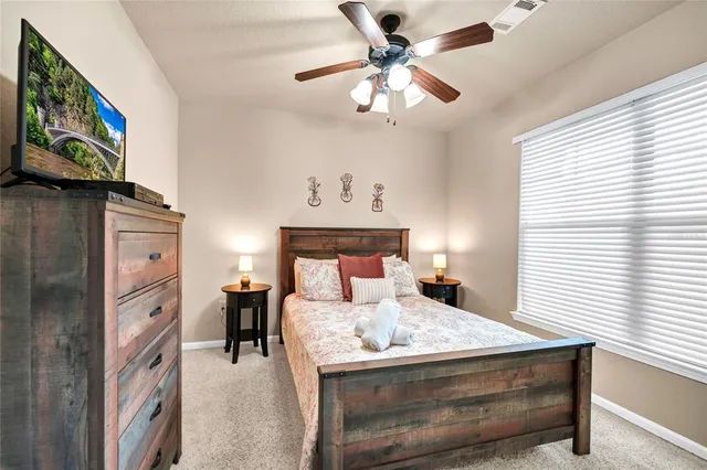 a bedroom with a bed and a lamp