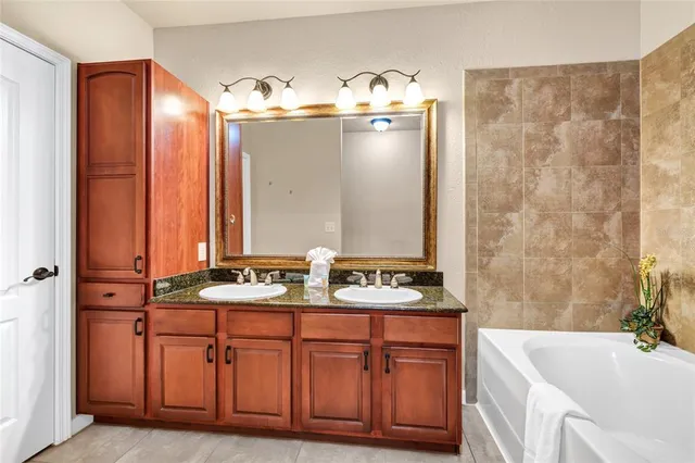 a bedroom with a bed and a flat tv screen on dresser