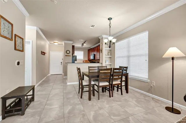 a view of a hallway with wooden cabinets and a living room